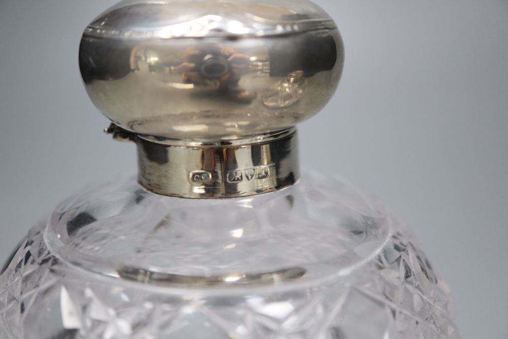 A Victorian silver mounted cut glass scent bottle, 12cm and an Edwardian silver mounted cut glass scent bottle.